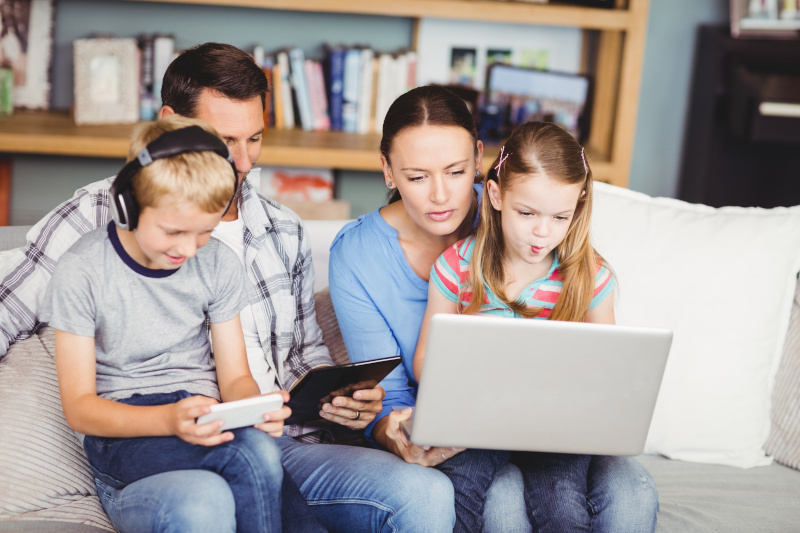 Broadband Providers young family with mobile devices